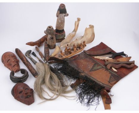 A Collection of Ethnic items,
including 3 fly whisks, a currency bangle, masks, Aboriginal stick, animal jaw bone, etc.