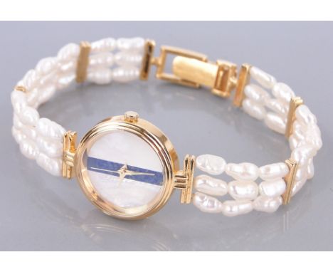 A lady's gold plated quartz wristwatch,
with lapis and mother of pearl dial and freshwater pearl strap.