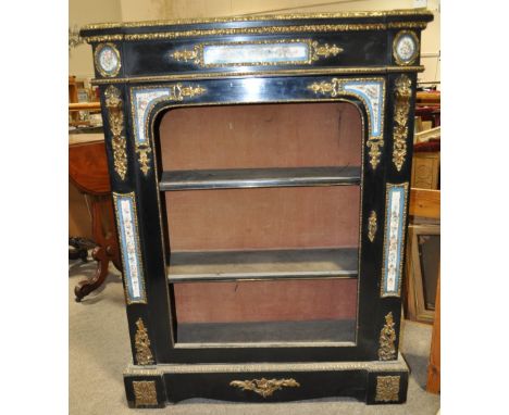 A 19th century continental ebonised pier cabinet,
with single door, having inset Sevres panels and allover ormolu mounts, wid
