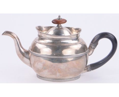 A George III silver teapot of bulbous oval form,
with Coromandel handle, makers marks I R, London 1803, 20.7 oz.