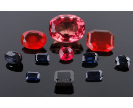 A group of unmounted cut gemstones,
including tourmaline, fire opal and sapphires.