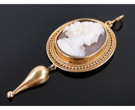 A 19th century carved Cameo set pendant,
depicting Classical portrait of a woman, unmarked setting tests as 15ct gold, length