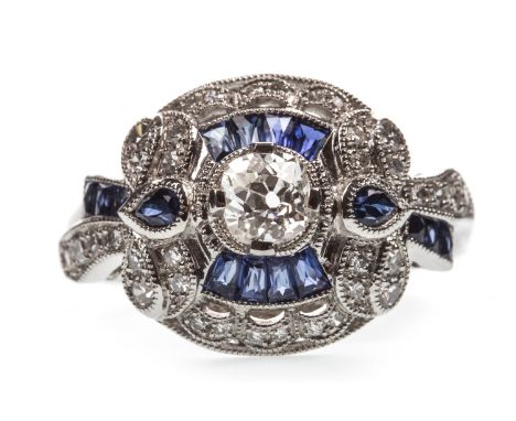 SAPPHIRE AND DIAMOND RING, the central old cut diamond of approximately 0.35 carats within a border of calibre cut sapphires 