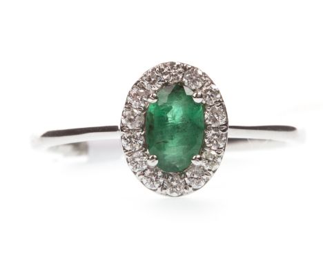 EMERALD AND DIAMOND RING, the oval emerald within a halo of round brilliant cut diamonds, the diamonds totalling approximatel