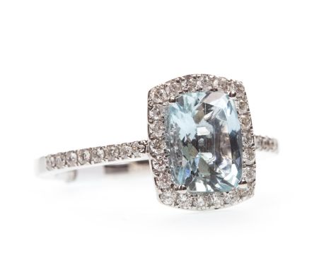 AQUAMARINE AND DIAMOND RING, the cushion shaped aquamarine within a round brilliant cut diamond halo, the diamonds totalling 