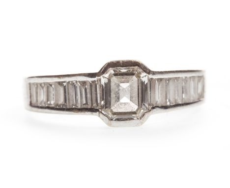 DIAMOND DRESS RING, set with a central emerald cut diamond of approximately 0.30 carats flanked by baguette cut diamonds tota