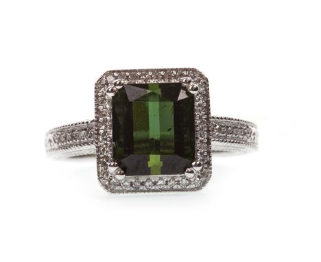 TOURMALINE AND DIAMOND RING, the step cut tourmaline within a diamond halo, on diamond shoulders with engraved decoration, th