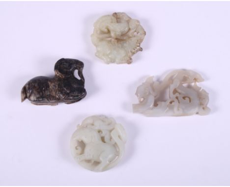 Two Chinese green jadeite/jade carved roundels, a Chinese grey jadeite/jade carving of a character and a dragon, and a black 