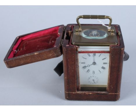 A French early 20th century brass carriage clock with white painted dial, Roman numerals and subsidiary second hand, in leath
