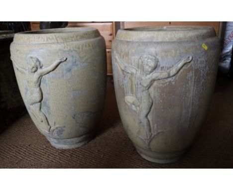 A pair of glazed ceramic planters with ovoid bodies moulded dancing figures, 24" high