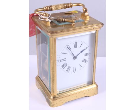 An hour repeater carriage  clock with a white enamel dial in brass case, 6" high