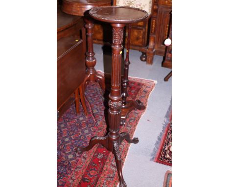 A 19th century mahogany torchere, with fluted column and tripod splay support, top 12" dia, and a mahogany torchere with flut
