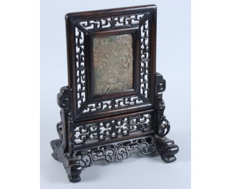 A Chinese pierced hardwood table screen and stand, inset with a jade panel of deer in a woodland landscape, 10 1/2" x 15" 