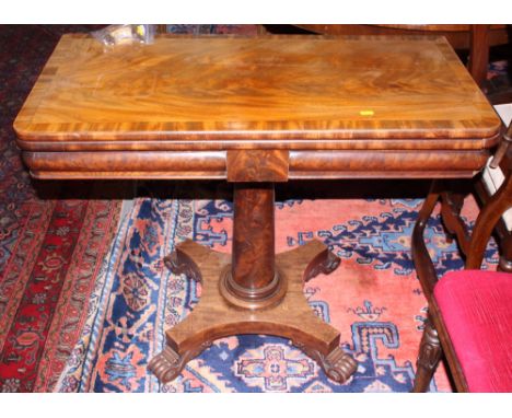 A 19th century mahogany fold-over top card table, on tapered column and shaped platform base, 36" wide