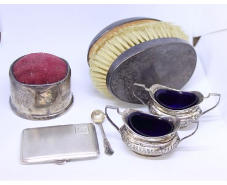 Two silver two-handled half-fluted salts, an engine turned cigarette case, a pair of silver backed hair brushes and a silver 