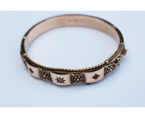 A 9ct gold ruby and diamond set bangle, 13.6g gross