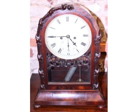 A mid 19th century mahogany bracket clock with eight-day striking movement in arch top case, on bun feet There are one or two