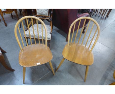 A pair of Ercol blonde chairs 