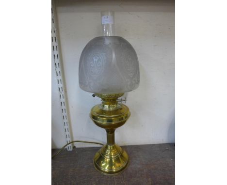A Victorian brass oil lamp with glass shade 