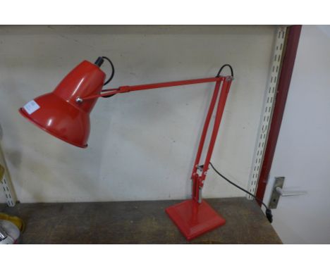 A red anglepoise lamp 