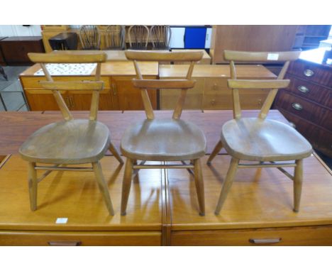 A set of three Ercol child's elm and beech yellow dot stacking chairs 