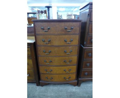 A walnut bow front chest of drawers 