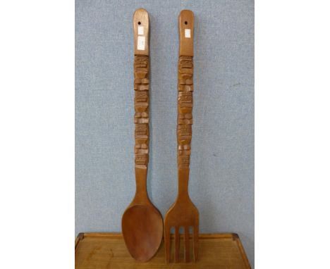 A large carved wood spoon and fork 