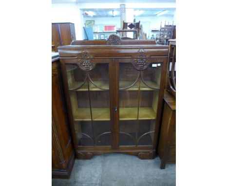 A carved oak two door bookcase 