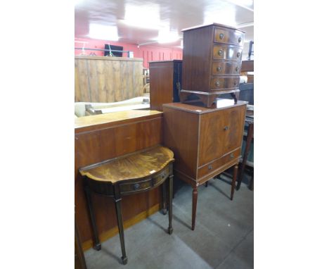 A small mahogany bow front chest of drawers, a hall table and a cocktail cabinet 