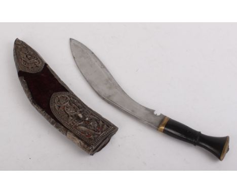 Indian Kukri, 11 ins blade, brass mounted ebonised grip in relief decorated filigree and feather metal and velvet scabbard