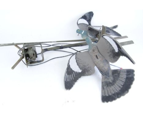 Rotary pigeon decoy with arms and two flapper decoy pigeons