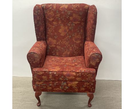 A large floral upholstered wing back armchair, H. 116cm.