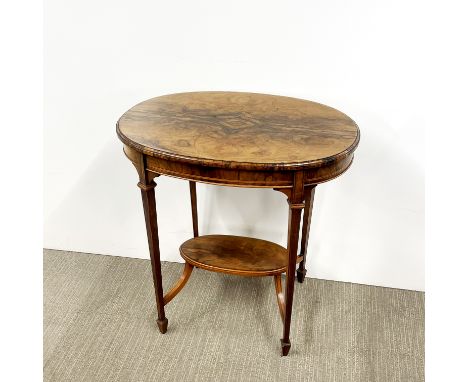 A two tier inlaid and figured mahogany oval side table, H. 70.5cm L. 69cm W. 46cm.
