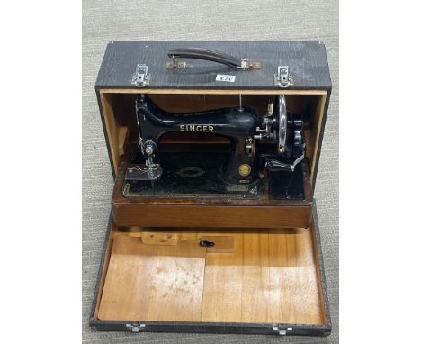 A cased antique Singer sewing machine.