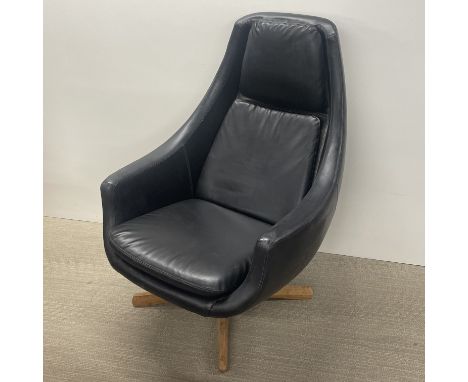 A mid century faux leather swivel armchair on a wooden base, H. 99cm.