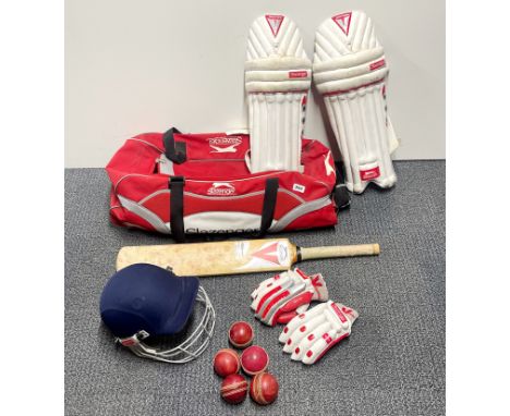 A large Slazenger sports bag with cricket equipment.