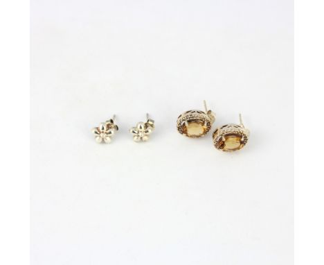 A pair of 925 silver stud earrings set with large faceted round cut champagne quartz and a pair of 925 silver flower stud ear