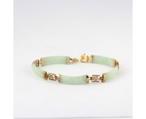 A 9ct yellow gold and jade set bracelet decorated with Chinese characters, L. 19.5cm.