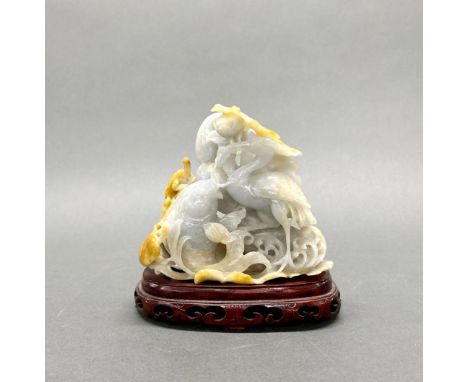 A fine Chinese carved celadon and russet jade figure of a lotus pond with a crane and a carp, together with a purpose made st