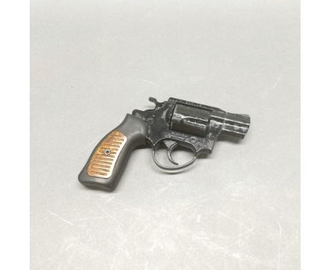A vintage metal toy revolver.