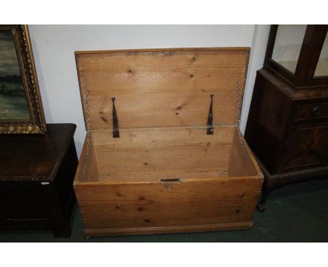 Pine trunk, with hinged lid, on a plinth base and castors, 92.5cm wide