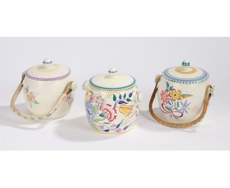 Three Poole pottery biscuit barrels and covers, two with swing handles, with foliate and insect decoration (3)