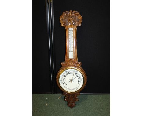 Oak aneroid barometer. with a thermometer and weather gauge, 85cm long