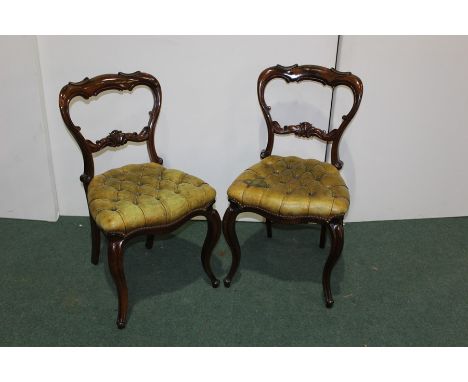 Pair of Victorian style walnut balloon back ding chairs, with green leather button upholstered seats, on cabriole legs