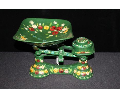 Set of barge ware style scales and weights, with painted floral decoration on a green ground