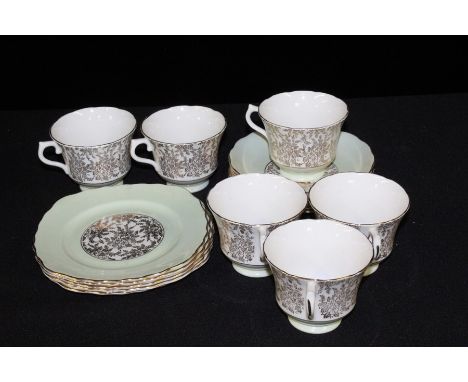 Royal Vale tea service with gilt foliate decoration on a green and white ground, consisting of six teacups, saucers and side 