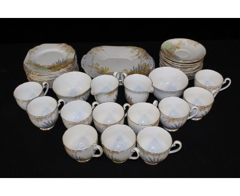 Melba bone china tea service, decorated with flowers in a country garden, consisting of two sandwich plates, two milk jugs, t