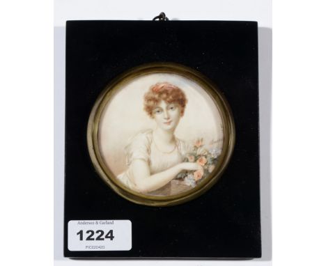 20th Century British School - a miniature bust portrait of a young woman with flowers, indistinctly signed (Iain?), body-colo