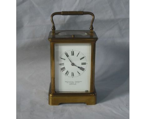 An early 20th century gilt brass carriage clock, the eight day repeating gong striking movement faced by enamel Roman dial na