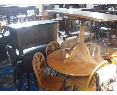 A modern pine drop-leaf kitchen dining table, together with a pine circular kitchen dining table and four wheel and stick-bac